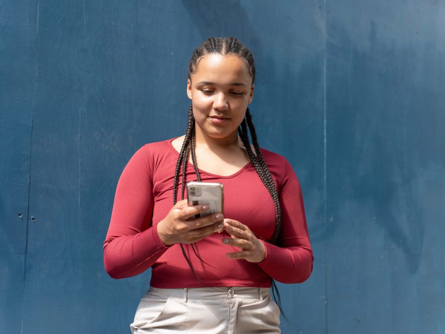 young african american woman looking at her phone